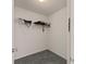 A walk-in closet with gray carpet flooring and a white wire rack for storage at 3971 Busby Mill Ct, Ellenwood, GA 30294
