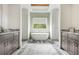 Bathroom showcasing a soaking tub with dual vanities, recessed lighting, and plank flooring at 4496 Sardis Church Rd, Buford, GA 30519