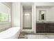 Beautiful bathroom featuring a modern tub, spacious vanity, and glass shower at 4496 Sardis Church Rd, Buford, GA 30519