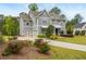 Beautiful two-story home with blue siding, a two-car garage, and landscaped front yard with red roses at 4496 Sardis Church Rd, Buford, GA 30519
