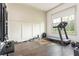 Well-equipped home gym featuring modern exercise equipment and natural light at 4496 Sardis Church Rd, Buford, GA 30519