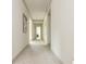 Hallway view with neutral carpet, showcasing the trim detail and natural light, enhances the home's design at 4496 Sardis Church Rd, Buford, GA 30519