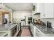 Modern kitchen with stainless steel appliances, granite countertops, and open layout at 4496 Sardis Church Rd, Buford, GA 30519