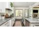 Modern kitchen with stainless steel appliances, granite countertops, and open layout at 4496 Sardis Church Rd, Buford, GA 30519