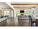 Bright, open living area showcases dark hardwood floors, beams and kitchen bar with stools at 4496 Sardis Church Rd, Buford, GA 30519