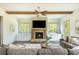 Cozy living room has a brick fireplace, built-in cabinets, and hardwood floors at 4496 Sardis Church Rd, Buford, GA 30519