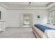 Bedroom showcasing a large bed and an open entrance to an ensuite bathroom with a soaking tub at 4496 Sardis Church Rd, Buford, GA 30519