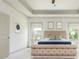 Main bedroom showcasing coffered ceilings, a fan, and large windows for natural light at 4496 Sardis Church Rd, Buford, GA 30519