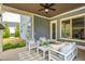 Covered patio with comfortable seating, ideal for relaxing while overlooking the beautifully landscaped yard at 4496 Sardis Church Rd, Buford, GA 30519