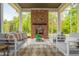 Charming outdoor patio featuring a brick fireplace, stylish seating, and views of the lush yard at 4496 Sardis Church Rd, Buford, GA 30519