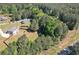 An aerial view of the home including a spacious yard with trees and outdoor play equipment at 524 Trousseau Ln, Mcdonough, GA 30252