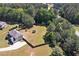 Aerial view of a home featuring a large yard, privacy fence, lush trees, and ample space at 524 Trousseau Ln, Mcdonough, GA 30252