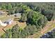 Aerial view of a home with a long driveway and large, fenced backyard surrounded by woods at 524 Trousseau Ln, Mcdonough, GA 30252