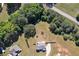 Aerial view of a home with large backyard including green grass and trees, and a privacy fence at 524 Trousseau Ln, Mcdonough, GA 30252