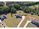 Aerial view of a home with a large backyard, driveway, and surrounding greenery at 524 Trousseau Ln, Mcdonough, GA 30252