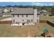 Large backyard featuring a patio, play area, and fenced perimeter at 524 Trousseau Ln, Mcdonough, GA 30252
