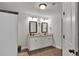 Bathroom features a double vanity with granite countertops, white cabinets, and dark tiled floors at 524 Trousseau Ln, Mcdonough, GA 30252