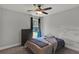 Neutral bedroom with a ceiling fan, dresser, and a window with natural light at 524 Trousseau Ln, Mcdonough, GA 30252