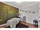 Inviting bedroom featuring a unique accent wall with lush greenery and stylish decor at 524 Trousseau Ln, Mcdonough, GA 30252