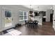 Bright dining area with a view to the backyard, table seating, and modern lighting fixtures at 524 Trousseau Ln, Mcdonough, GA 30252