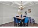 Bright dining area showcasing a coffered ceiling, modern chandelier, marble table, and stylish decor at 524 Trousseau Ln, Mcdonough, GA 30252