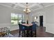 Bright dining space with coffered ceilings, wood floors, and a view to the backyard at 524 Trousseau Ln, Mcdonough, GA 30252