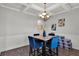 Elegant dining area with coffered ceilings, stylish chandelier, and seating for four at 524 Trousseau Ln, Mcdonough, GA 30252
