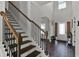 Inviting foyer with a staircase, wood floors, and natural light streaming in from the front door at 524 Trousseau Ln, Mcdonough, GA 30252