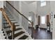 Inviting foyer featuring a staircase with decorative iron spindles and a view of the front door at 524 Trousseau Ln, Mcdonough, GA 30252