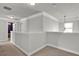 Upstairs hallway featuring neutral carpet and trim at 524 Trousseau Ln, Mcdonough, GA 30252