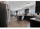 Open-concept kitchen with black cabinetry, granite countertops, and seamless flow into the adjacent living area at 524 Trousseau Ln, Mcdonough, GA 30252