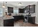 Modern kitchen featuring black cabinets, granite countertops, stainless steel appliances, and hardwood floors at 524 Trousseau Ln, Mcdonough, GA 30252