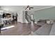 Open-concept living area with hardwood floors and staircase, seamlessly connected to the dining area at 524 Trousseau Ln, Mcdonough, GA 30252