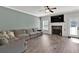 Cozy living room featuring a fireplace, TV, comfortable seating and lots of natural light at 524 Trousseau Ln, Mcdonough, GA 30252