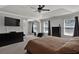 Relaxing main bedroom featuring a large bed, tray ceiling, and plenty of natural light at 524 Trousseau Ln, Mcdonough, GA 30252