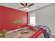 Bright playroom featuring a red accent wall, play slide, table, and assorted toys at 524 Trousseau Ln, Mcdonough, GA 30252