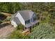 Aerial view of home showcasing its location, surrounding trees, and driveway at 550 Vinings Springs Se Dr, Mableton, GA 30126