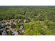 Aerial shot of neighborhood showcasing the home's location within a wooded community at 550 Vinings Springs Se Dr, Mableton, GA 30126