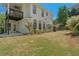 A spacious backyard featuring green grass, string lights, and blossoming rose bushes at 550 Vinings Springs Se Dr, Mableton, GA 30126