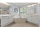 Bright bathroom with dual sink vanities, tile floors, and a large soaking tub perfect for relaxation at 550 Vinings Springs Se Dr, Mableton, GA 30126