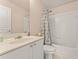 Neutral-toned bathroom features white vanity, bathtub and shower with chrome fixtures at 550 Vinings Springs Se Dr, Mableton, GA 30126