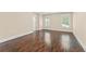 Spacious bedroom with hardwood floors, two windows with white frames, and neutral paint at 550 Vinings Springs Se Dr, Mableton, GA 30126