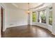 Dining area with wainscoting, bay window, chandelier, and access to the kitchen at 550 Vinings Springs Se Dr, Mableton, GA 30126