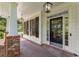 Inviting front door with sidelights and brick porch, complemented by exterior lighting and dark shutters at 550 Vinings Springs Se Dr, Mableton, GA 30126