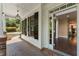 Covered porch with brick flooring, leading to the front door and a glimpse of the interior at 550 Vinings Springs Se Dr, Mableton, GA 30126