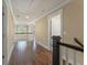 Well-lit upstairs hallway with hardwood floors, white trim, and access to multiple rooms at 550 Vinings Springs Se Dr, Mableton, GA 30126