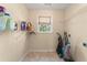 A functional laundry room featuring shelving and a window for natural light at 550 Vinings Springs Se Dr, Mableton, GA 30126