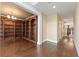 Hallway view connecting the library with custom wood shelving to other areas of the home at 550 Vinings Springs Se Dr, Mableton, GA 30126