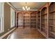Library with custom built-in wood bookshelves, hardwood floors, and natural light at 550 Vinings Springs Se Dr, Mableton, GA 30126