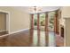 Bright living room with a fireplace and multiple arched windows with wooded views at 550 Vinings Springs Se Dr, Mableton, GA 30126